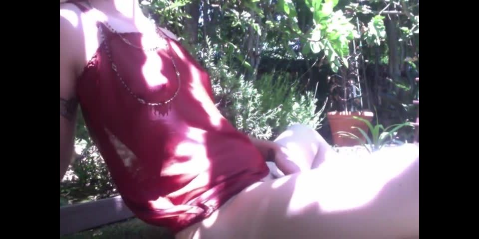 Blonde girl fingering hairy pussy in garden