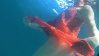 Rusalka Red dressed mermaid Rusalka swimming in the pool