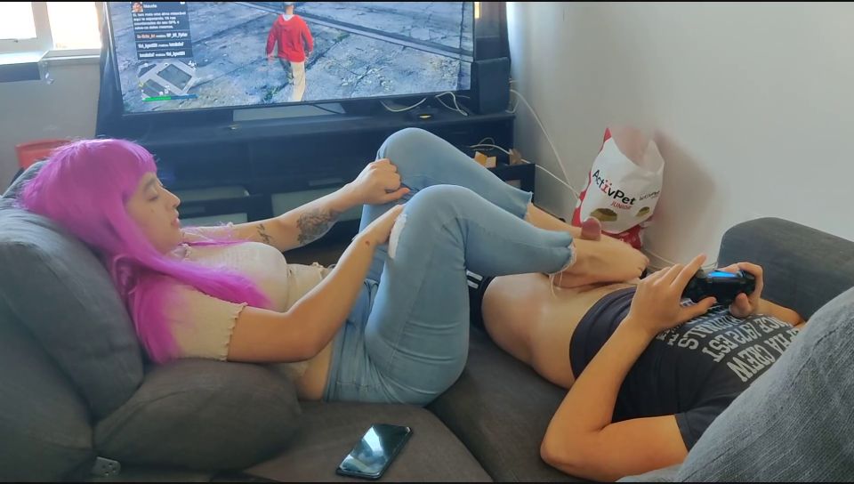 Miss Squirting Stepsister jerks stepbrother with her feet while he plays playstation