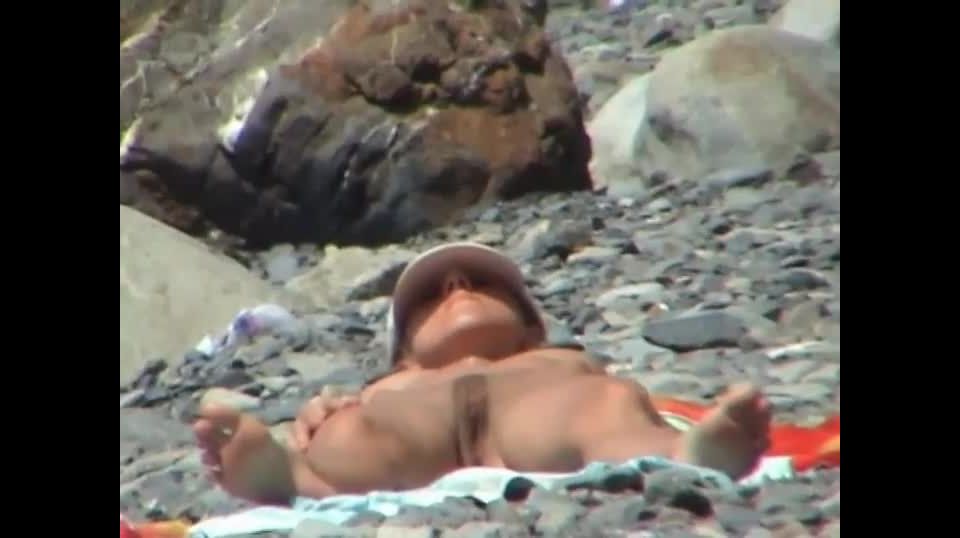 Inviting pose of a naked beach  girl