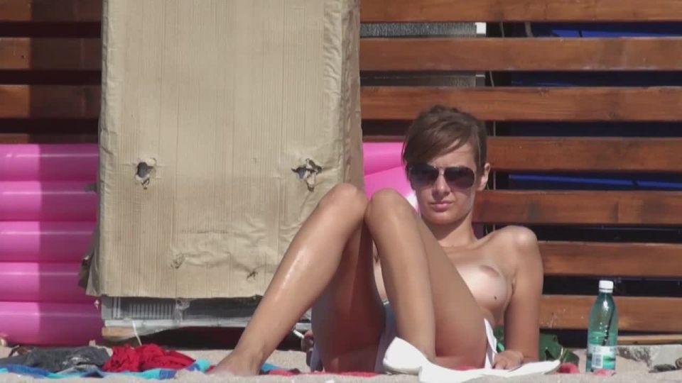 Topless girl smokes a  cigarette